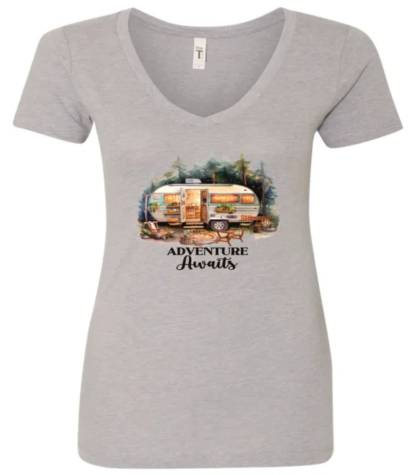 silver camping v-neck t-shirt featuring a camper in the woods in the night with open doors with a quote saying adventure awaits