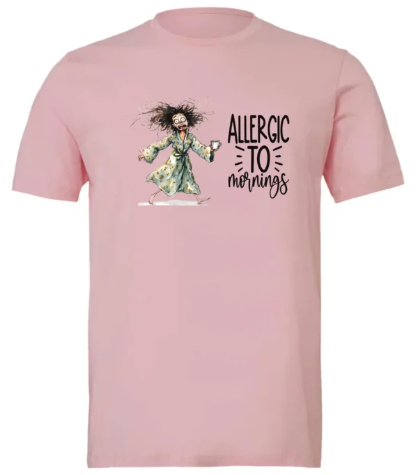 pink funny coffee t-shirt featuring a disheveled woman with scared face running in pajamas and a cup of coffee, it says allergic to mornings