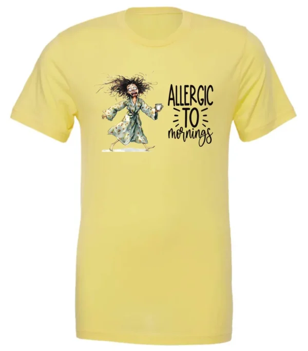 yellow funny coffee t-shirt featuring a disheveled woman with scared face running in pajamas and a cup of coffee, it says allergic to mornings