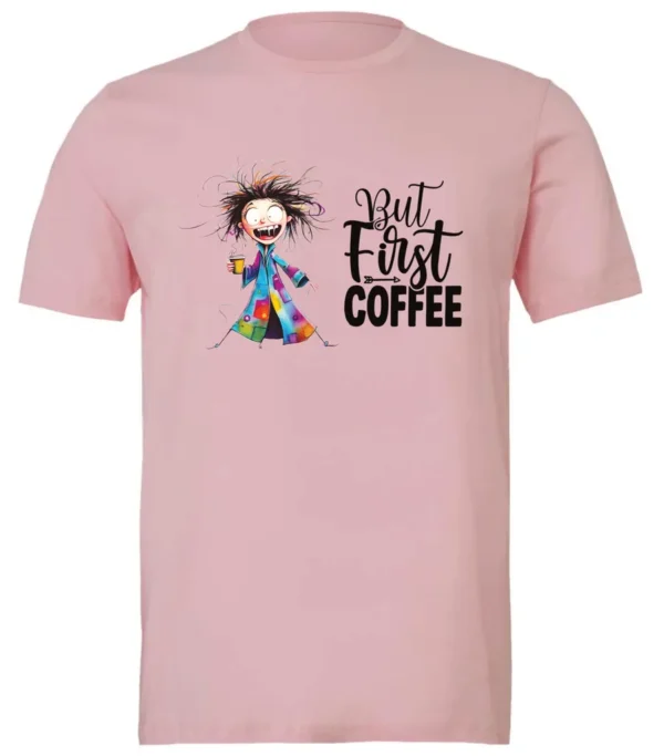 pink coffee addict t-shirt featuring a disheveled young woman with surprised face in pajamas and a cup of coffee, it says but first coffee