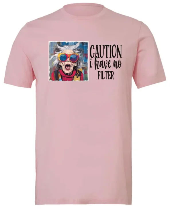 pink sarcasm t-shirt featuring a funny design of a disheveled older woman with white hair and big glasses, saying Caution: I have no filter