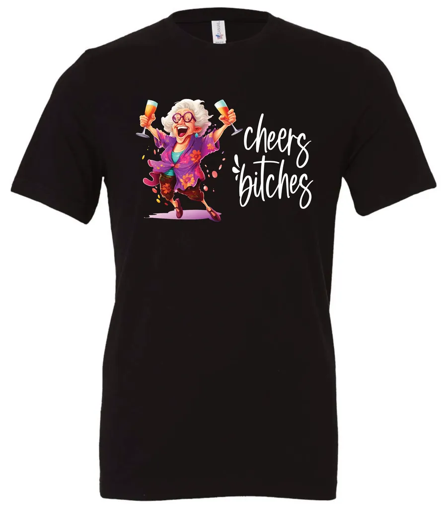 black funny cocktail t-shirt featuring a drunk old woman with glasses dancing and holding a glass of cocktail in each hand and it says cheers bitches