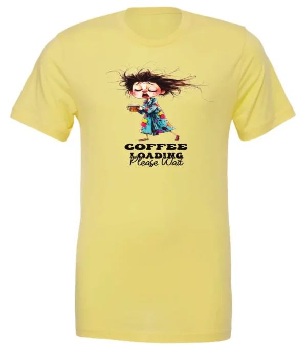yellow coffee t-shirt featuring a disheveled young woman with eyes closed in pajamas with a cup of coffee, it says coffee loading please wait