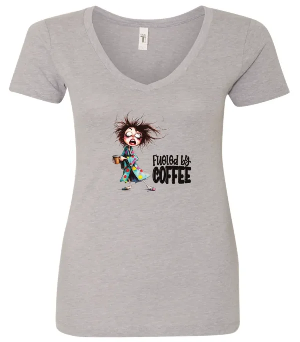 silver coffee lover v-neck t-shirt featuring a disheveled young woman who just woke up in pajamas with a cup of coffee it says fueled by coffee