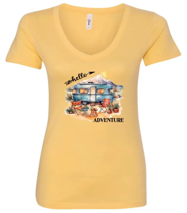 yellow camping v-neck t-shirt featuring a camper, picnic table set outside, and a sunrise in the background, and it says hello adventure