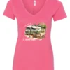 pink camping v-neck t-shirt featuring an old model camper in the woods with a table and chairs outside, and it says I’d rather be camping