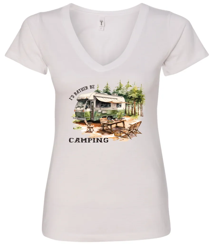 white camping v-neck t-shirt featuring an old model camper in the woods with a table and chairs outside, and it says I’d rather be camping