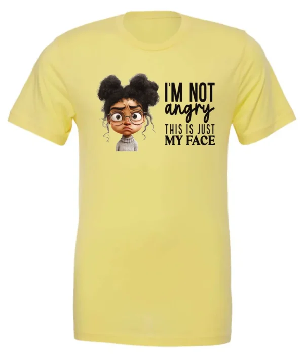 yellow funny sarcastic t-shirt featuring a young black girl with two hair buns, glasses and angry face saying I'm not angry, this is just my face