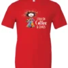 red caffeine t-shirt featuring a disheveled woman with a colorful coat mouth and eyes wide open and a cup of coffee it says I run on coffee and chaos
