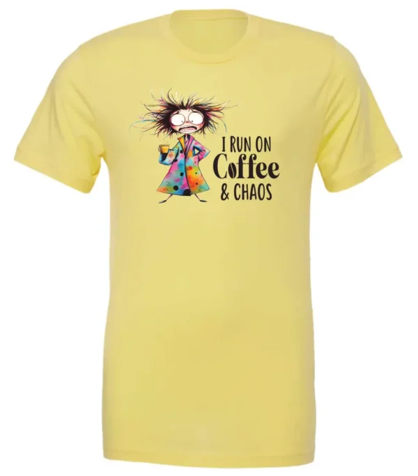 yellow caffeine t-shirt featuring a disheveled woman with a colorful coat mouth and eyes wide open and a cup of coffee it says I run on coffee and chaos