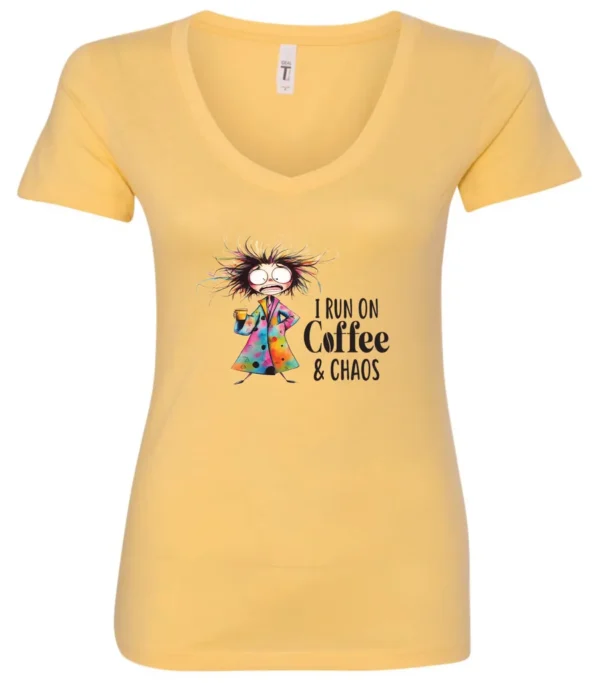 yellow caffeine v-neck t-shirt featuring a disheveled woman with a colorful coat mouth and eyes wide open and a cup of coffee it says I run on coffee and chaos