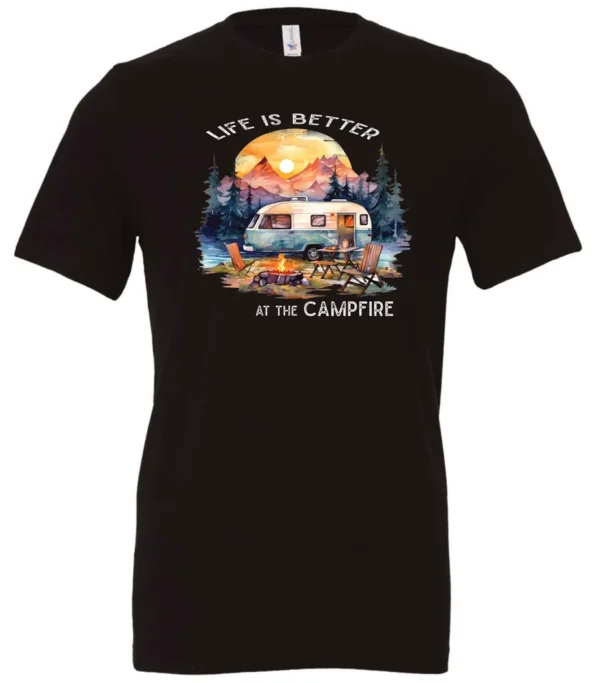 black campfire t-shirt featuring a camper by the lake, campfire on, and mountains with a sunset in the background, and it says life is better at the campfire.
