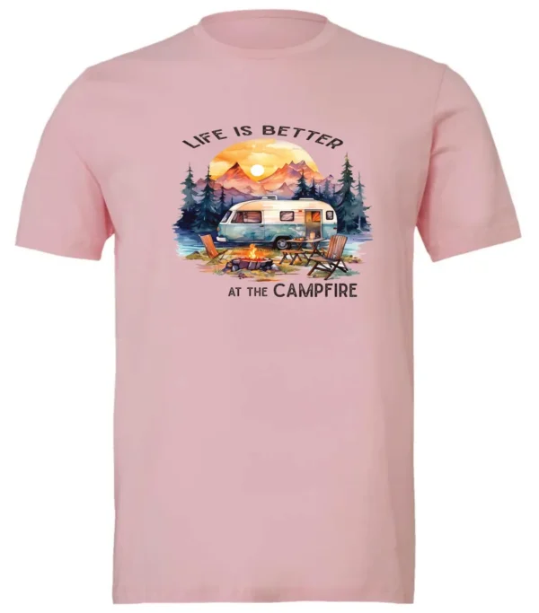 pink campfire t-shirt featuring a camper by the lake, campfire on, and mountains with a sunset in the background, and it says life is better at the campfire.