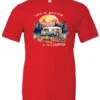 red campfire t-shirt featuring a camper by the lake, campfire on, and mountains with a sunset in the background, and it says life is better at the campfire.