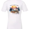 white campfire t-shirt featuring a camper by the lake, campfire on, and mountains with a sunset in the background, and it says life is better at the campfire.