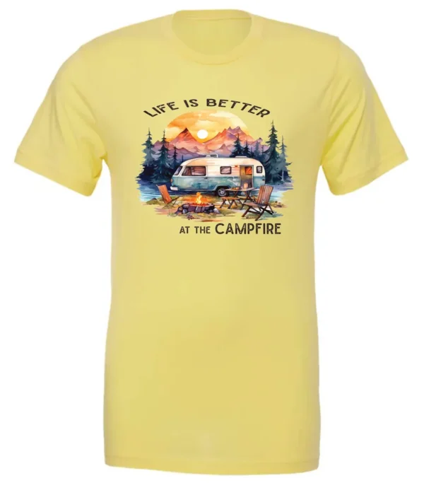 yellow campfire t-shirt featuring a camper by the lake, campfire on, and mountains with a sunset in the background, and it says life is better at the campfire.