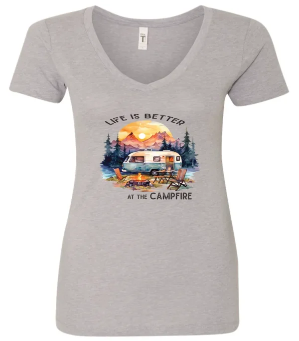 silver campfire v-neck t-shirt featuring a camper by the lake, campfire on, and mountains with a sunset in the background, and it says life is better at the campfire.