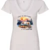 white campfire v-neck t-shirt featuring a camper by the lake, campfire on, and mountains with a sunset in the background, and it says life is better at the campfire.