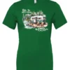 green Camping graphic t-shirt featuring a white and red old camper set up by the lake in the woods, and it says life is better in the woods