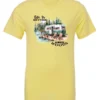 yellow Camping graphic t-shirt featuring a white and red old camper set up by the lake in the woods, and it says life is better in the woods