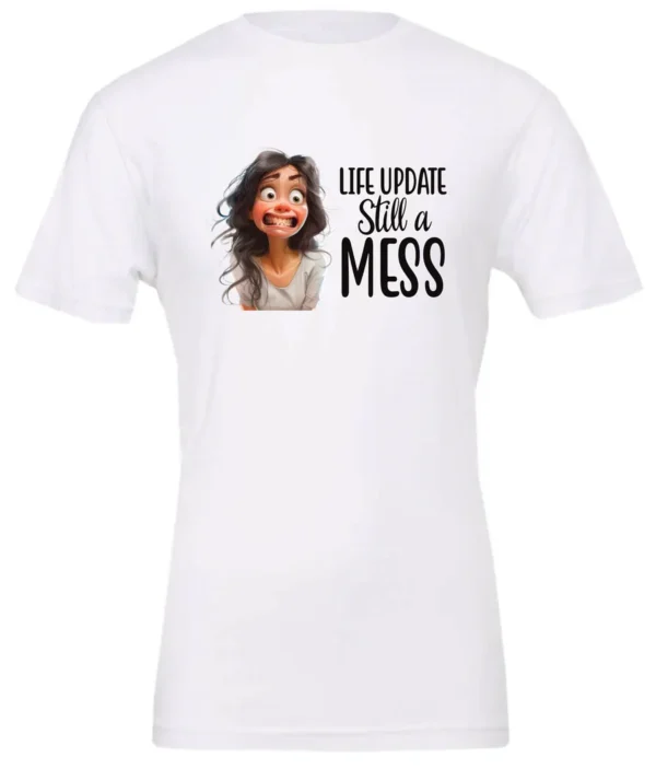 white funny saying t-shirt featuring a young girl with long brown hair, with an embarrassed face saying life update, still a mess