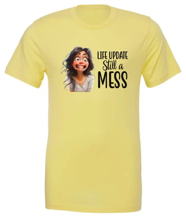 yellow funny saying t-shirt featuring a young girl with long brown hair, with an embarrassed face saying life update, still a mess