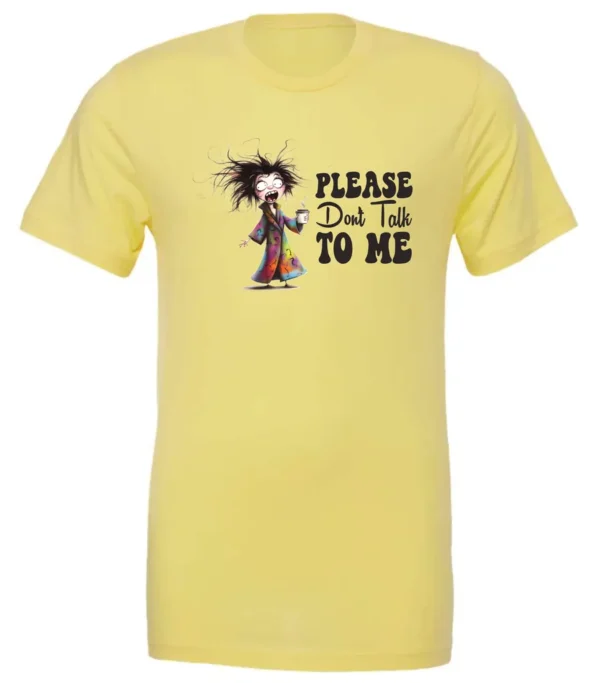 yellow funny sarcasm t-shirt featuring a woman who has just woken up in pajamas, disheveled, with a cup of coffee in her hand and screaming please don’t talk to me