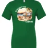 green funny Camping t-shirt featuring a camper set up by the beach with the mountain as background, and it says retirement plan: camping