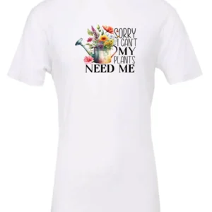 white garden humor t-shirt with a watering can used as a flower pot, it has many different flowers and a quote saying sorry i can't, my plants need me