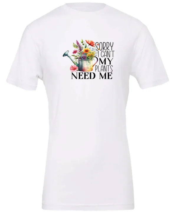 white garden humor t-shirt with a watering can used as a flower pot, it has many different flowers and a quote saying sorry i can't, my plants need me