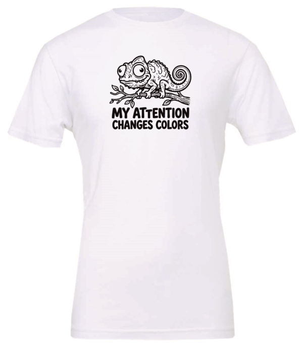 white t-shirt with a chameleon on a tree branch saying my attention changes colors