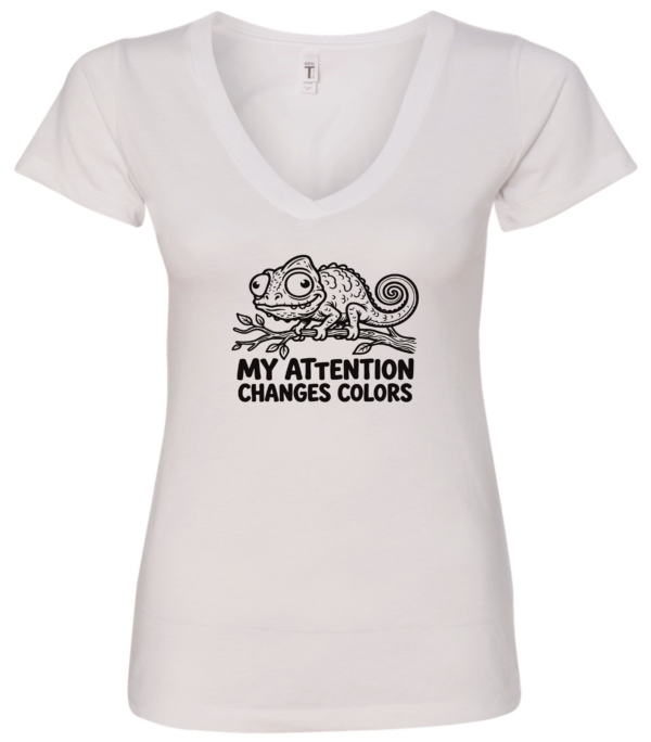 white v-neck t-shirt with a chameleon on a tree branch saying my attention changes colors